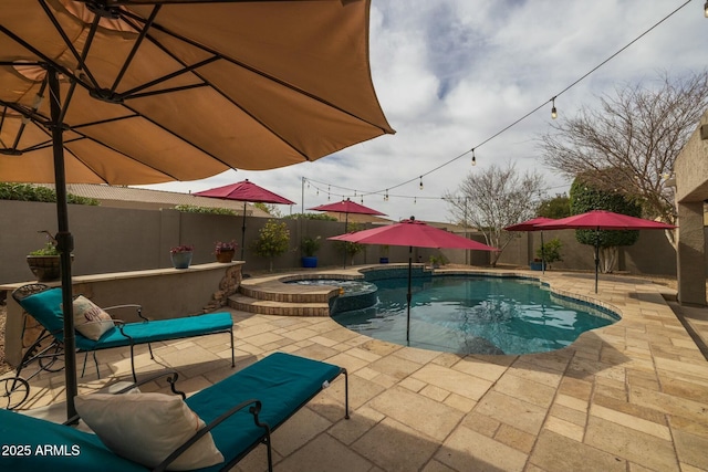 view of swimming pool with an in ground hot tub and a patio