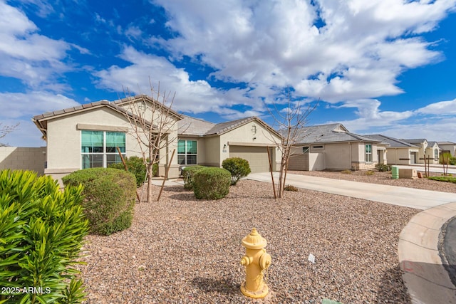 single story home with stucco siding, concrete driveway, an attached garage, and a tiled roof