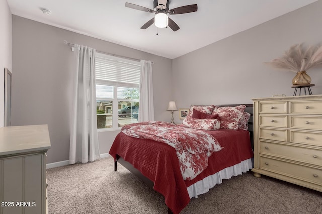 carpeted bedroom with a ceiling fan and baseboards