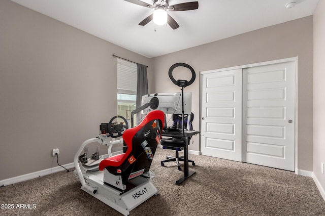 exercise area with carpet flooring, baseboards, and ceiling fan