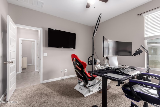 office space with baseboards, carpet, visible vents, and ceiling fan