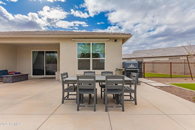 view of patio / terrace with outdoor dining area and fence