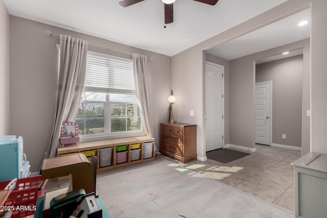 interior space with baseboards and a ceiling fan