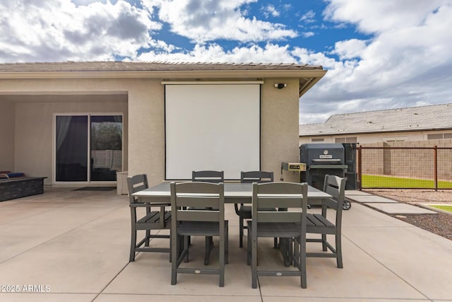 view of patio / terrace with outdoor dining area and fence