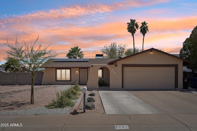 207 E Strahan Dr, Tempe, AZ 85283 - single story home with a garage, stucco siding, roof mounted solar panels, and driveway