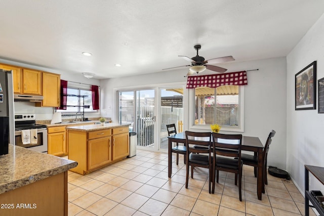 207 E Strahan Dr, Tempe, AZ 85283 - kitchen with electric stove, under cabinet range hood, light countertops, a sink, and light tile patterned floors