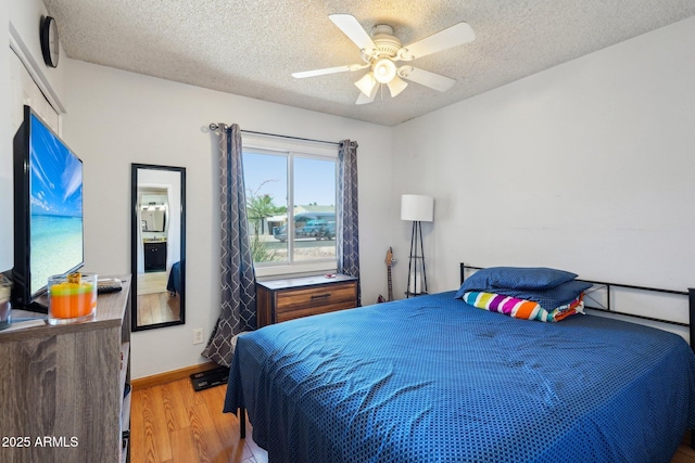 207 E Strahan Dr, Tempe, AZ 85283 - bedroom featuring wood finished floors, a textured ceiling, ceiling fan, and baseboards