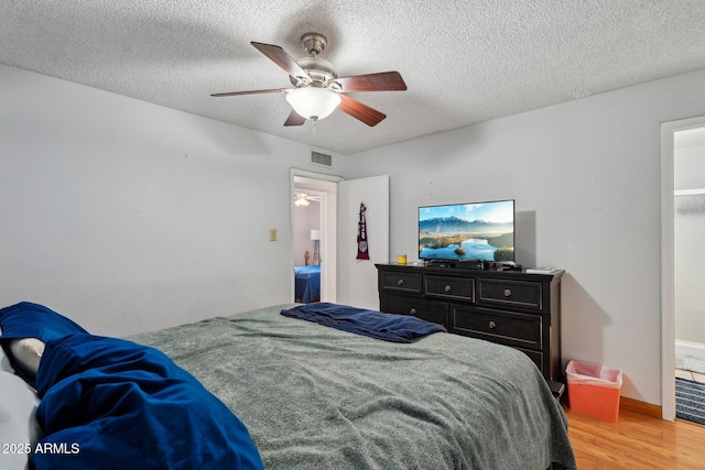 207 E Strahan Dr, Tempe, AZ 85283 - bedroom with light wood-style floors, a textured ceiling, and a ceiling fan