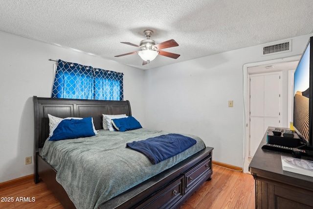 207 E Strahan Dr, Tempe, AZ 85283 - bedroom with light wood-style flooring, baseboards, a textured ceiling, and ceiling fan