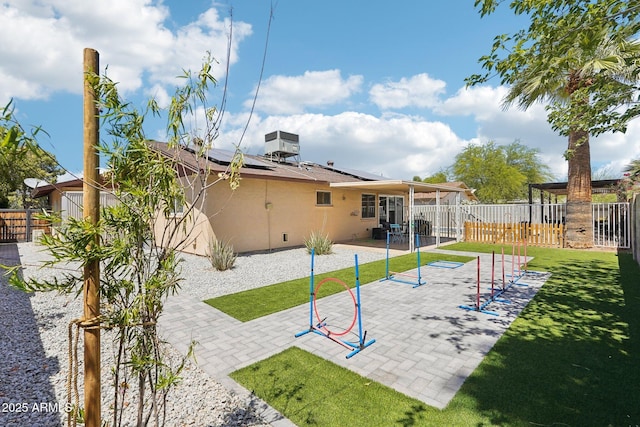 207 E Strahan Dr, Tempe, AZ 85283 - back of property featuring stucco siding, roof mounted solar panels, and a patio area