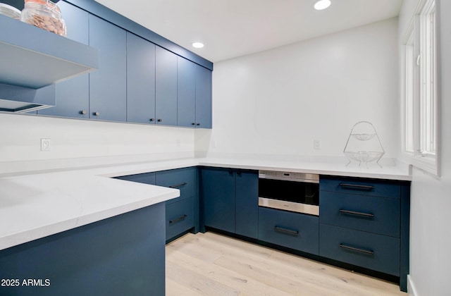 1712 E Fairfield St, Mesa, AZ 85203 - kitchen featuring blue cabinetry, wall oven, light wood-style flooring, and recessed lighting