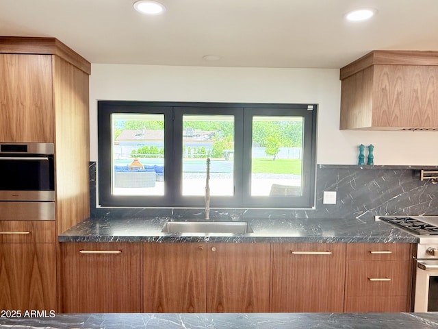 1712 E Fairfield St, Mesa, AZ 85203 - kitchen featuring healthy amount of natural light, dark stone countertops, oven, and recessed lighting