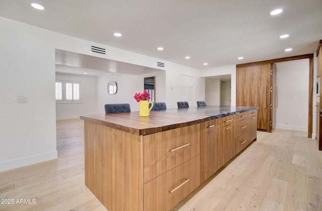 1712 E Fairfield St, Mesa, AZ 85203 - kitchen with wooden counters, light wood-style flooring, modern cabinets, recessed lighting, and a large island