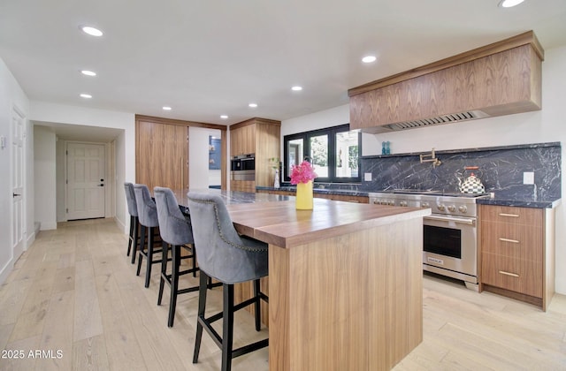 1712 E Fairfield St, Mesa, AZ 85203 - kitchen with appliances with stainless steel finishes, recessed lighting, wood counters, light wood-style flooring, and decorative backsplash
