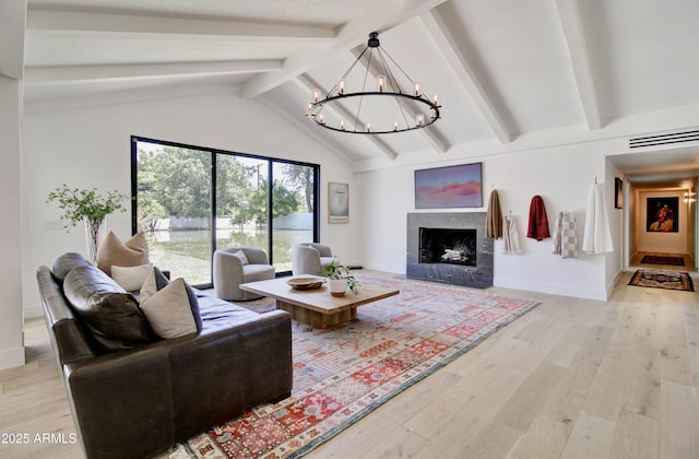 1712 E Fairfield St, Mesa, AZ 85203 - living room with light wood-style floors, beam ceiling, a chandelier, a fireplace, and high vaulted ceiling
