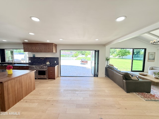 1712 E Fairfield St, Mesa, AZ 85203 - kitchen featuring double oven range, light wood-type flooring, open floor plan, recessed lighting, and wooden counters