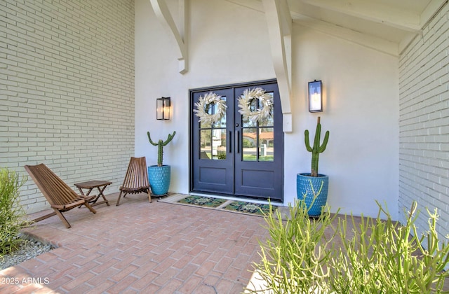 1712 E Fairfield St, Mesa, AZ 85203 - view of exterior entry featuring french doors, stucco siding, and brick siding