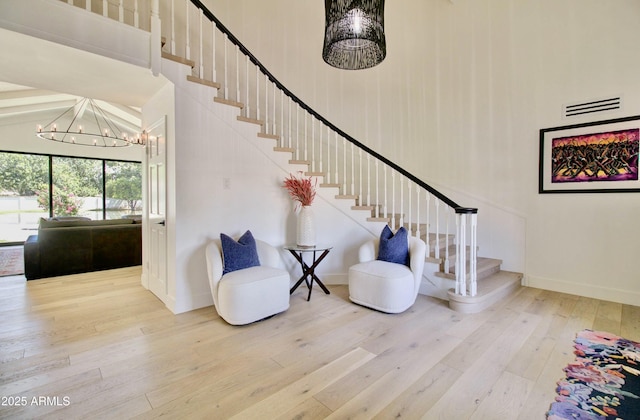 1712 E Fairfield St, Mesa, AZ 85203 - stairs with a chandelier, hardwood / wood-style floors, and a towering ceiling