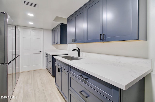 1712 E Fairfield St, Mesa, AZ 85203 - kitchen featuring freestanding refrigerator, recessed lighting, and light stone countertops