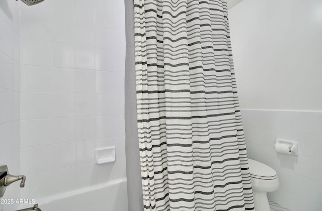 1712 E Fairfield St, Mesa, AZ 85203 - full bathroom featuring shower / bath combo with shower curtain, tile walls, and a wainscoted wall