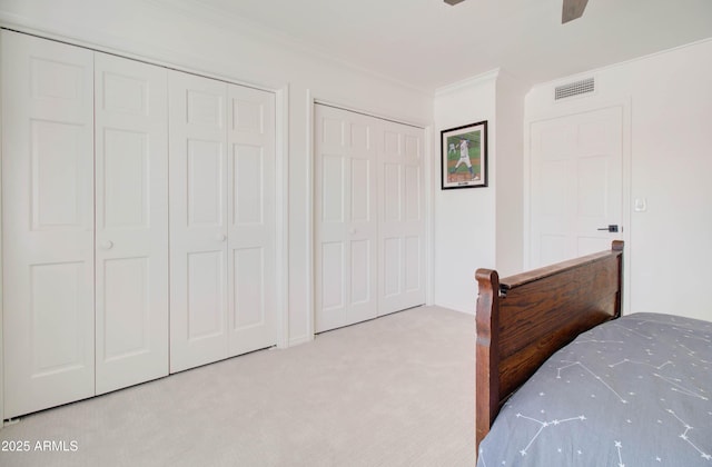 1712 E Fairfield St, Mesa, AZ 85203 - bedroom featuring crown molding, two closets, light carpet, and a ceiling fan
