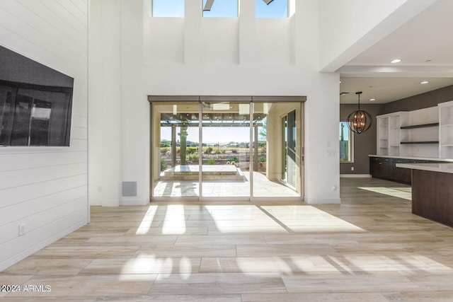 interior space featuring a towering ceiling and a wealth of natural light