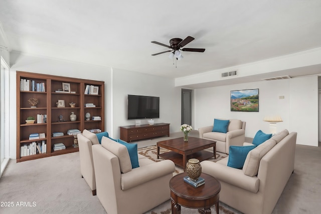 living area with light carpet, ceiling fan, and visible vents