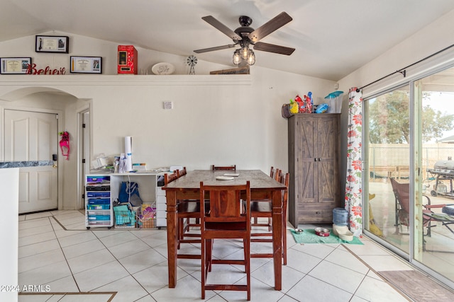 tiled dining area featuring vaulted ceiling and ceiling fan