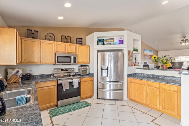 kitchen featuring appliances with stainless steel finishes, ceiling fan, sink, light tile patterned floors, and lofted ceiling