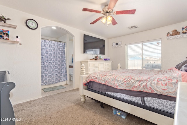 bedroom with carpet, ceiling fan, and connected bathroom