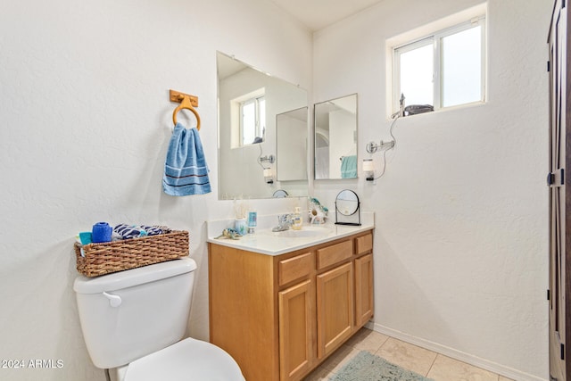 bathroom featuring tile patterned floors, vanity, and toilet