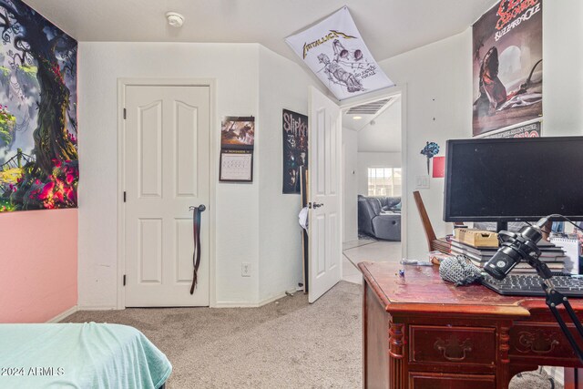 bedroom featuring light carpet and vaulted ceiling