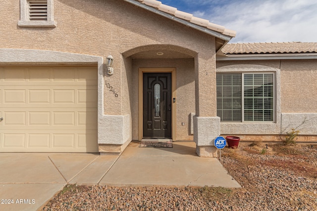 doorway to property with a garage