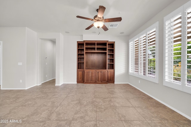 unfurnished living room featuring baseboards, ceiling fan, and visible vents