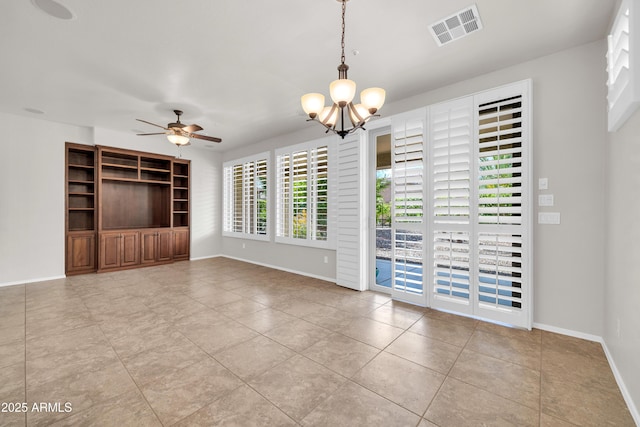 interior space featuring baseboards, visible vents, and ceiling fan with notable chandelier