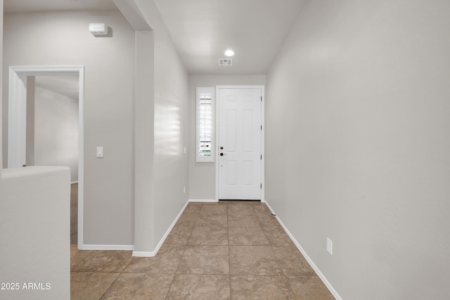 interior space featuring baseboards and visible vents