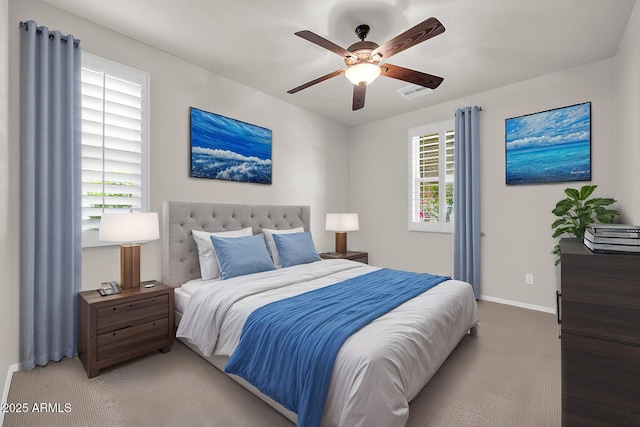 bedroom featuring carpet, baseboards, ceiling fan, and visible vents