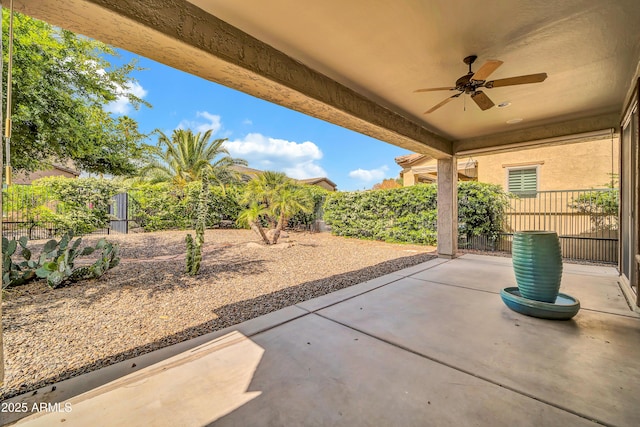 view of patio / terrace with a ceiling fan and fence