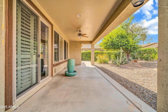 view of patio with fence and a ceiling fan