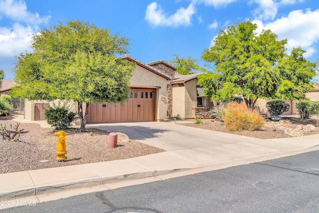 view of property hidden behind natural elements with concrete driveway, stucco siding, fence, an attached garage, and a tiled roof