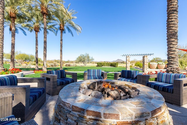 view of patio / terrace with an outdoor living space with a fire pit and a pergola