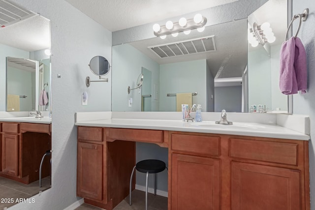 bathroom with vanity, tile patterned flooring, and a textured ceiling