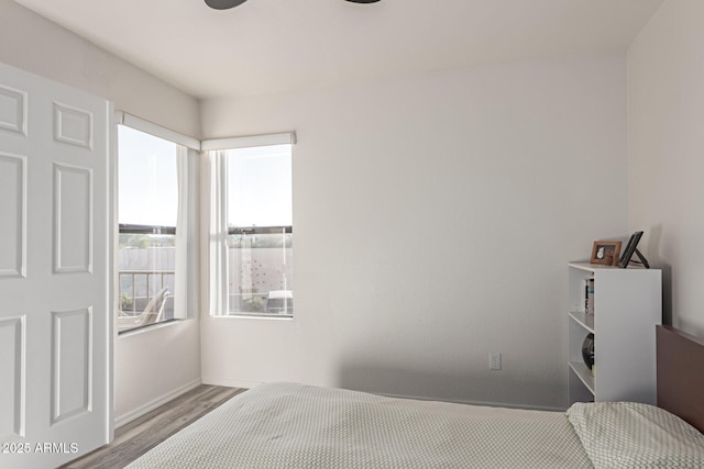 bedroom with light hardwood / wood-style floors and ceiling fan