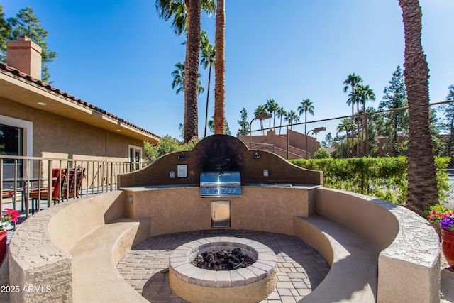 view of patio / terrace with area for grilling, grilling area, and an outdoor fire pit