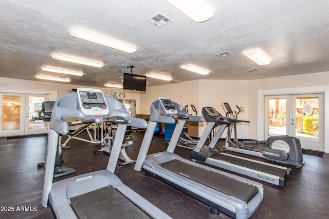 exercise room featuring french doors and a textured ceiling