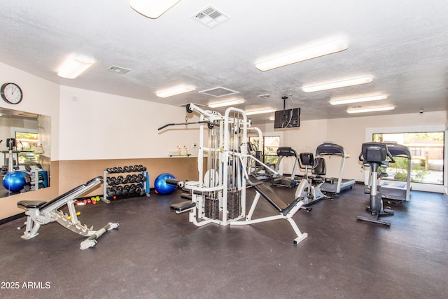 workout area with a textured ceiling