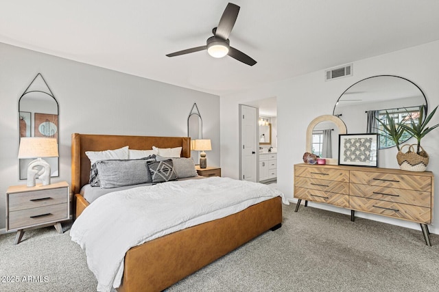 carpeted bedroom featuring ensuite bathroom and ceiling fan