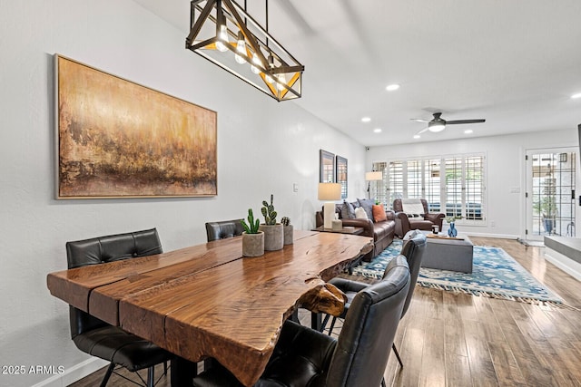 dining space with ceiling fan and hardwood / wood-style floors