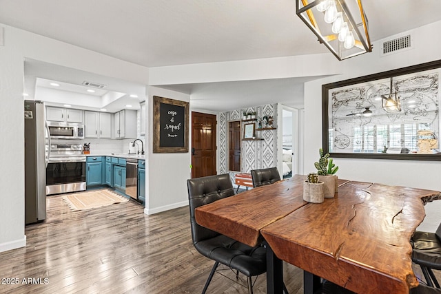 dining area featuring hardwood / wood-style flooring and sink