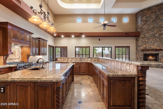 3523 E Presidio Cir, Mesa, AZ 85213 - kitchen featuring a sink, a large island, a high ceiling, ceiling fan, and tasteful backsplash